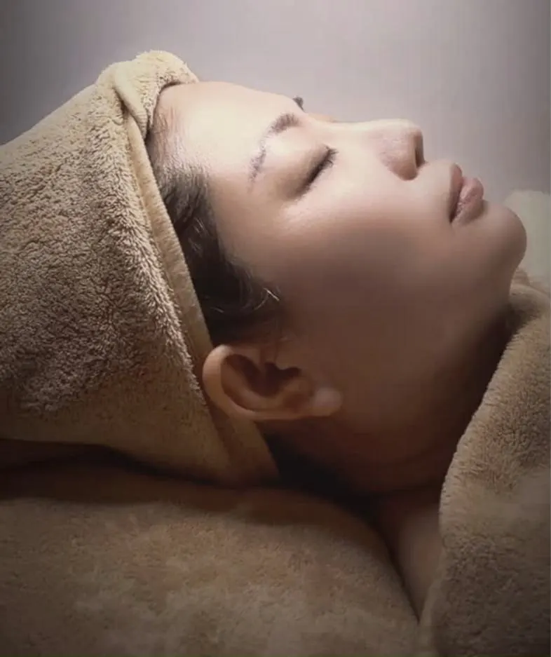 A client relaxing during a skin management facial