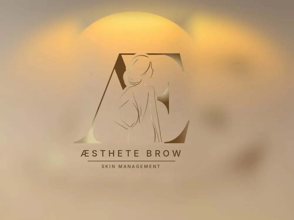 The lit Aesthete Brow and Skin Management sign, a goddess figure inside the letters A and E